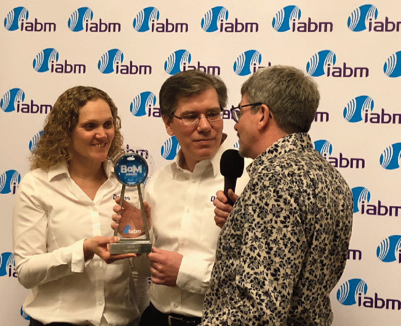 Todd Scneider and Yvonne Monteresso recieving their Award from IABM’s Stan Moote